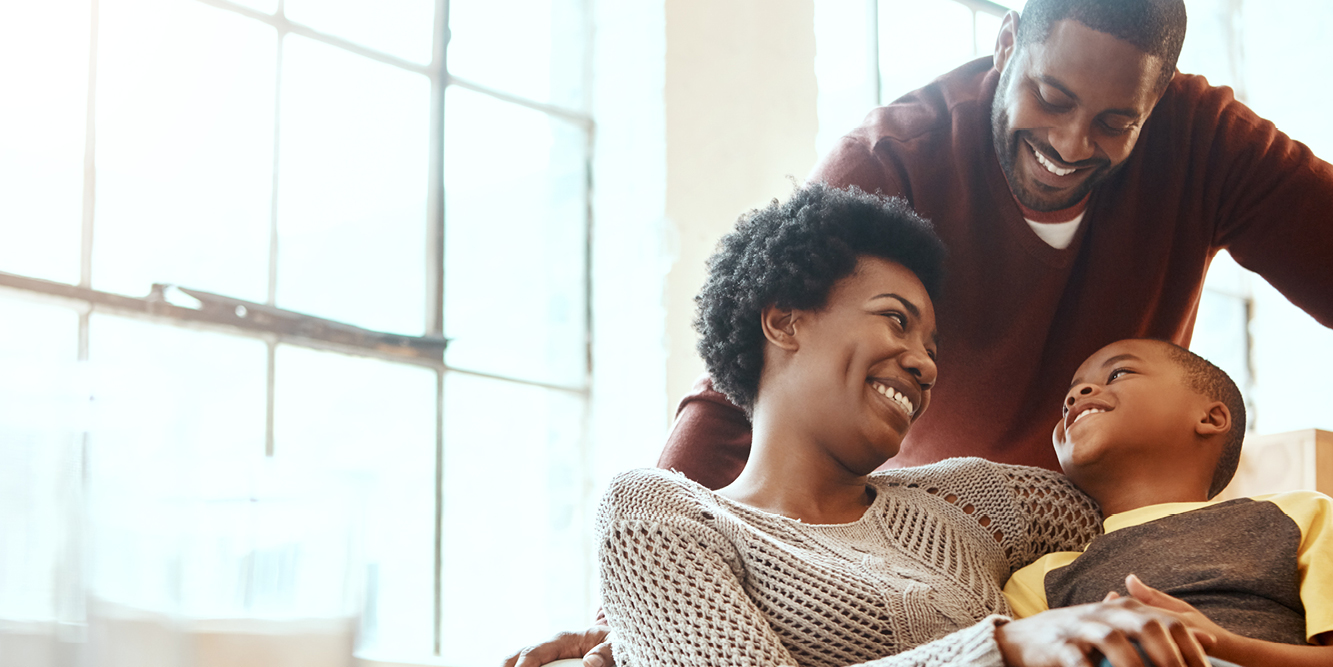 family laughing on couch